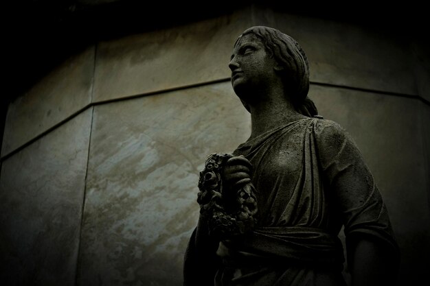 Low angle view of female statue