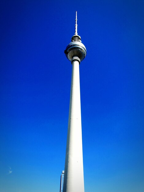 Low angle view of fernsehturm against blue sky