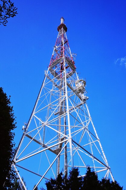 Low angle view of ferris wheel against blue sky