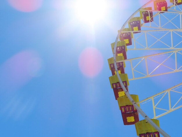 Photo low angle view of ferris wheel against blue sky