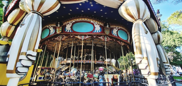 Low angle view of ferris wheel against buildings