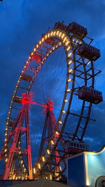 Low angle view of ferris wheel against sky at night