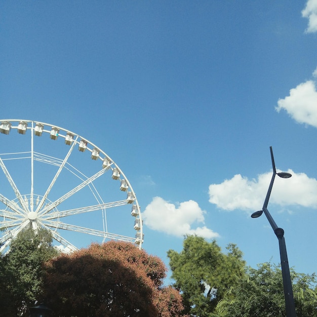 Low angle view of ferris wheel against sky