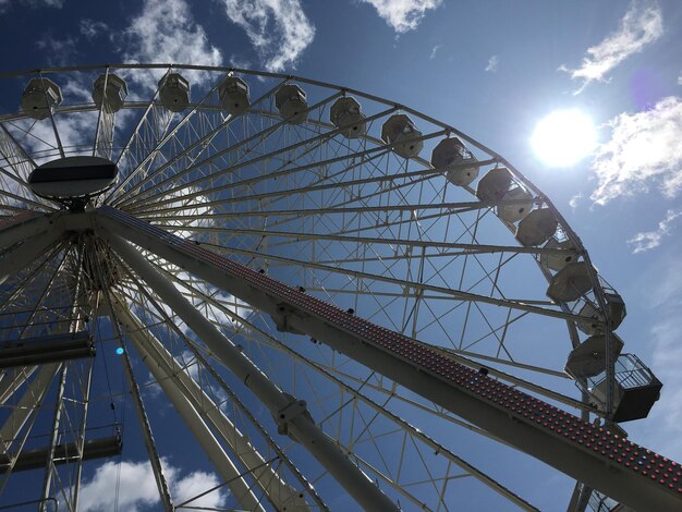 Low angle view of ferris wheel against sky