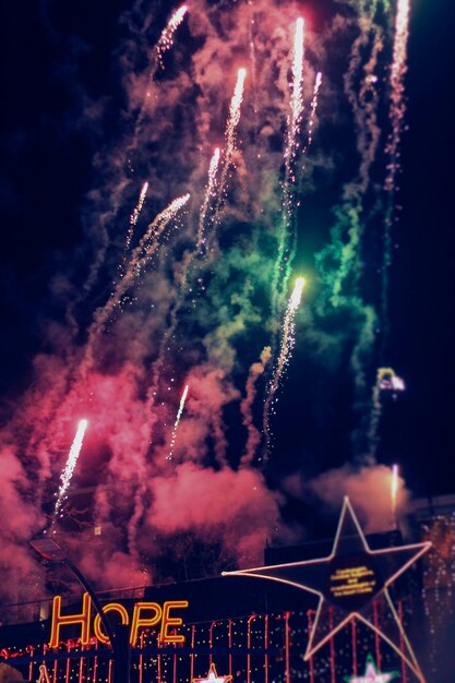 Photo low angle view of firework display against sky at night