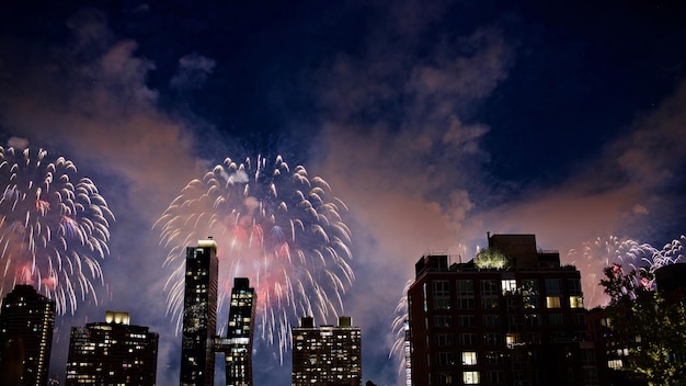 low angle view of firework display over buildings at night