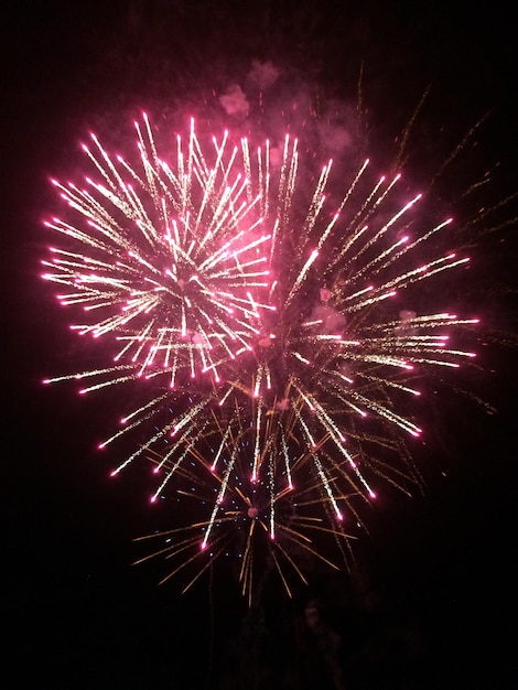 Low angle view of firework display at night