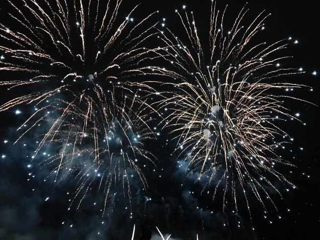 Low angle view of firework display at night