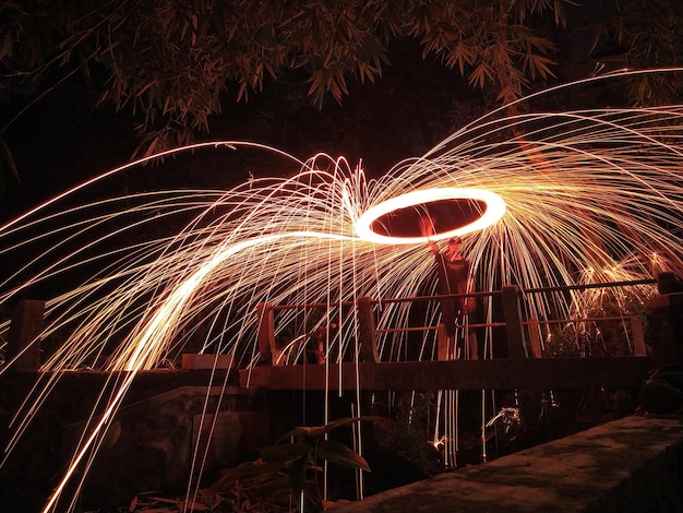 Low angle view of firework display at night