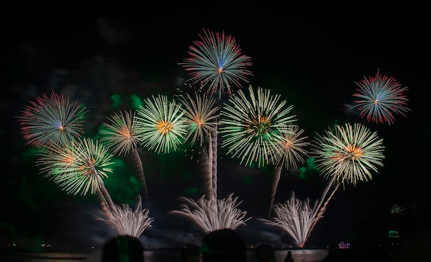 Low angle view of firework display at night