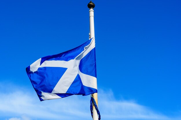 Low angle view of flag against blue sky