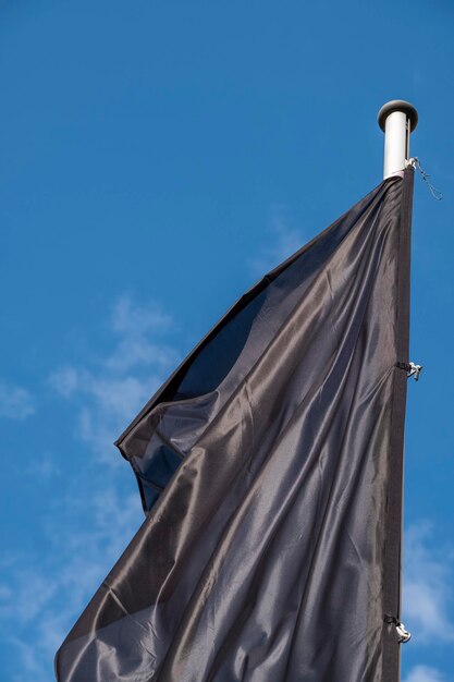 Low angle view of flag against blue sky