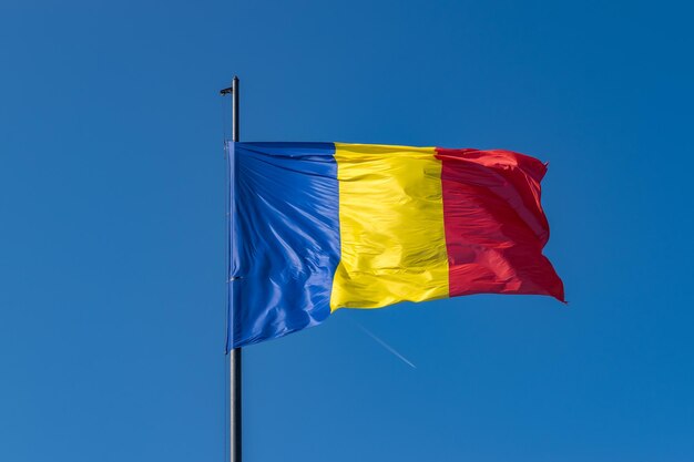 Low angle view of flag against blue sky