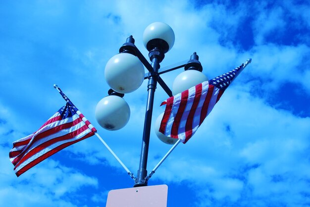 Low angle view of flag against blue sky