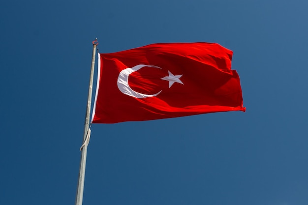 Low angle view of flag against blue sky