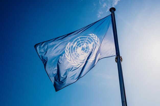 Low angle view of flag against blue sky