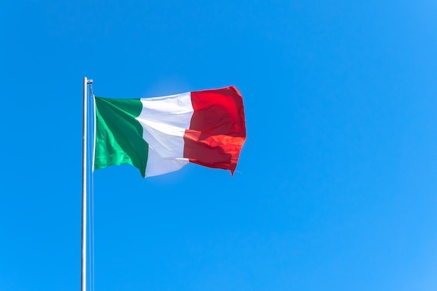 Low angle view of flag against blue sky