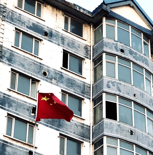 Low angle view of flag against building