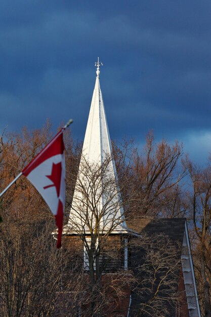 Low angle view of flag by building against sky