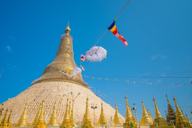 Low angle view of flags against clear blue sky