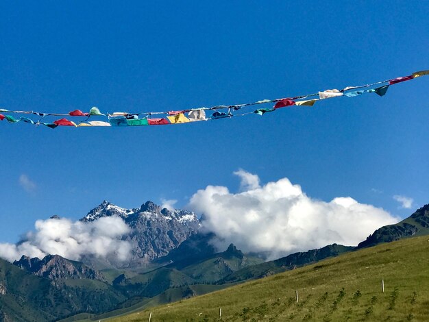 Low angle view of flags against mountain range