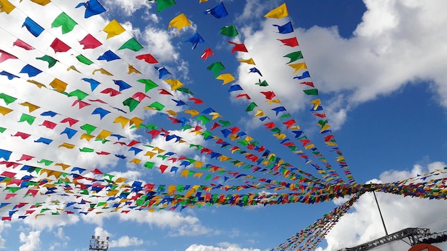 low angle view of flags hanging against sky