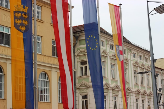 Low angle view of flags hanging in front of buildings on street