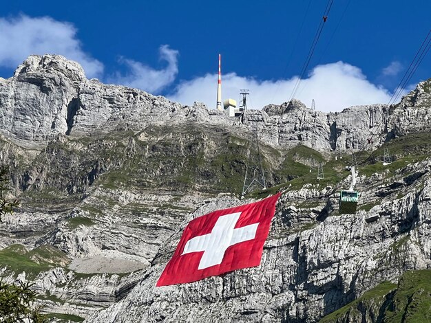 Low angle view of flags on mountain against sky