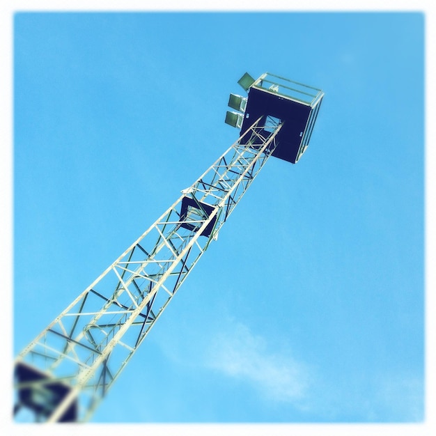 Low angle view of floodlight against blue sky