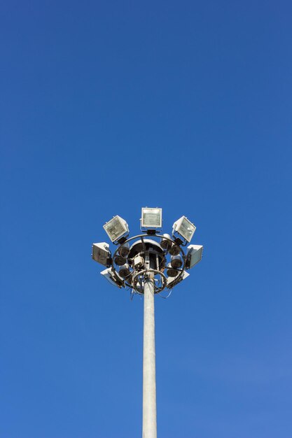 Low angle view of floodlight against blue sky