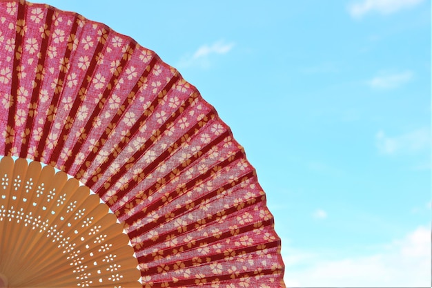 Low angle view of folding fan against blue sky