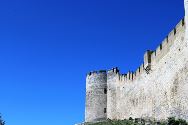 Low angle view of fort against clear blue sky