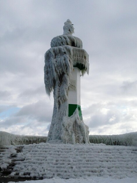 Low angle view of frozen lighthouse