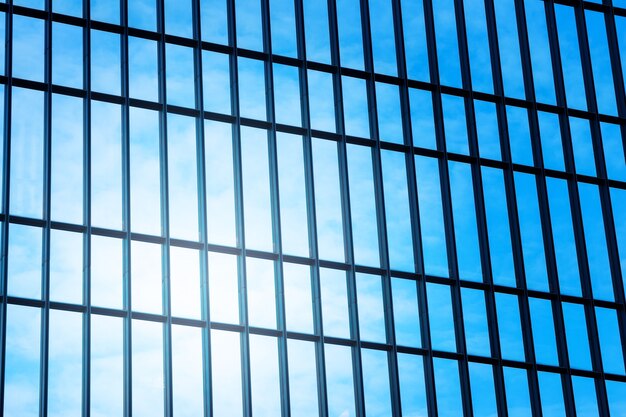 Low angle view to glass window of modern skyscraper.