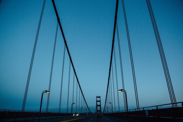 Low angle view of golden gate bridge against clear blue sky