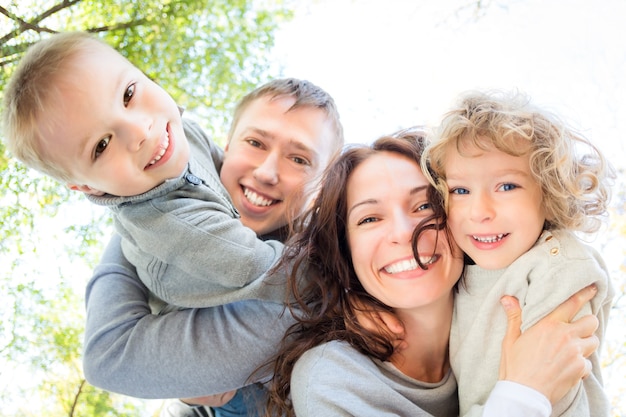 Low angle view of happy family in autumn park