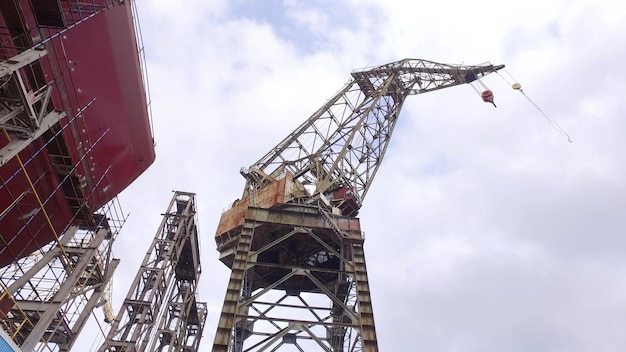 Low angle view of harbor crane Crane for loading cargo in seaport