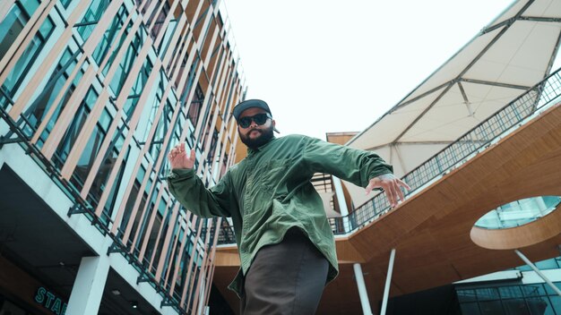 Low angle view of hipster pose in hip hop style surrounded by mall Endeavor