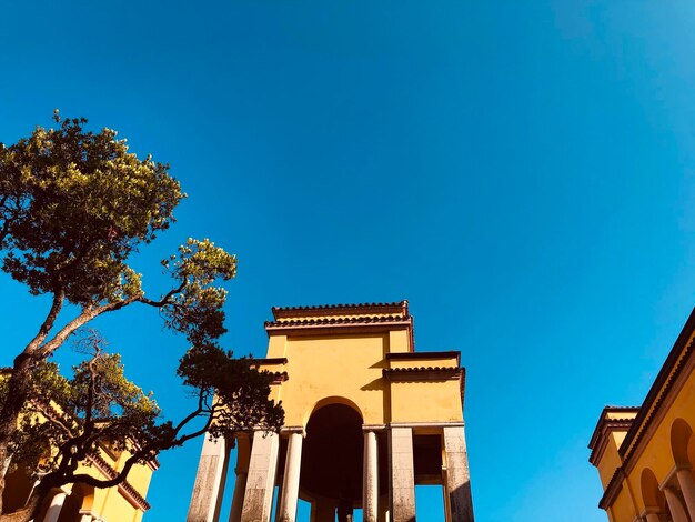 Low angle view of historic building against clear blue sky