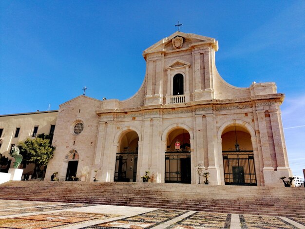 Low angle view of historic building against clear blue sky