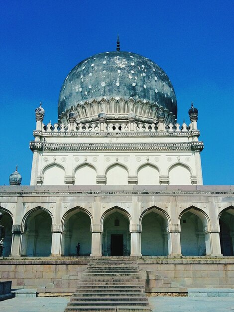 Low angle view of historical building against clear blue sky