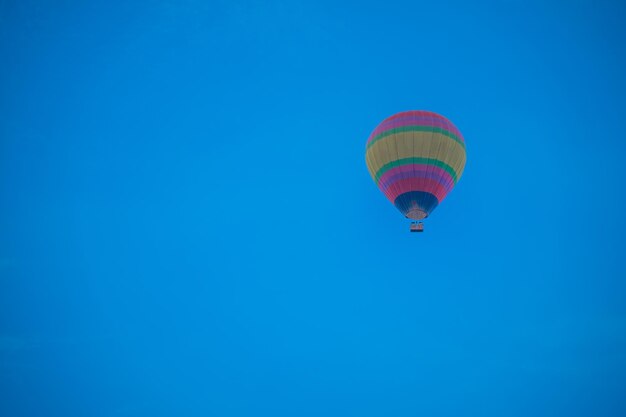 Low angle view of hot air balloon against clear blue sky