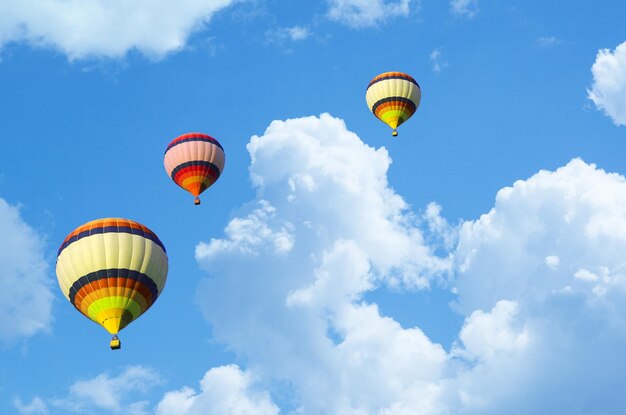 Low angle view of hot air balloons flying against sky