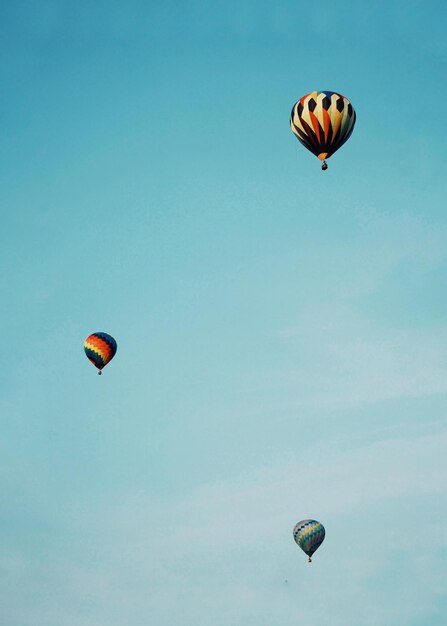 Low angle view of hot air balloons flying in sky