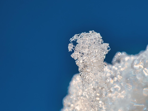 Low angle view of ice against clear blue sky