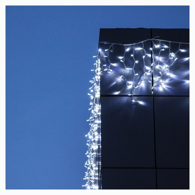 Photo low angle view of illuminated blue sky at night