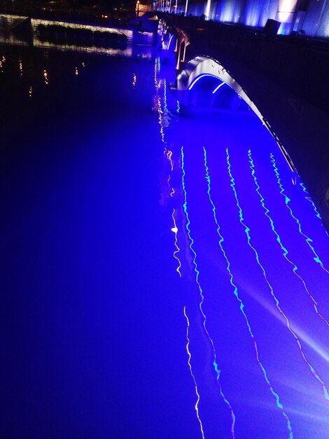 Low angle view of illuminated blue sky at night