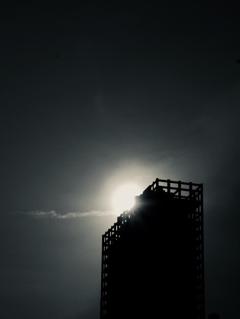 Low angle view of illuminated building against sky during sunset