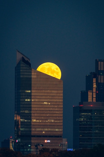 Low angle view of illuminated buildings against sky at night