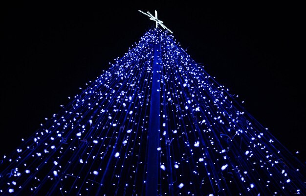 Low angle view of illuminated christmas decoration against clear sky at night